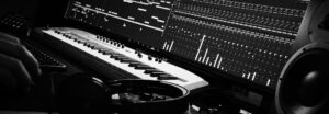 post production suite sound design with headphones and electronic keyboard